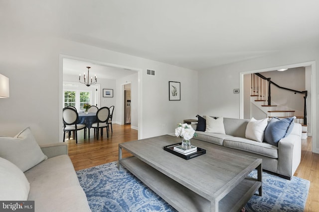 6134 Long Meadow Rd, Mclean, VA 22101 - living area featuring a chandelier, wood finished floors, and stairs