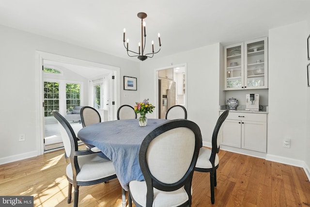 6134 Long Meadow Rd, Mclean, VA 22101 - dining area with light wood finished floors and a chandelier