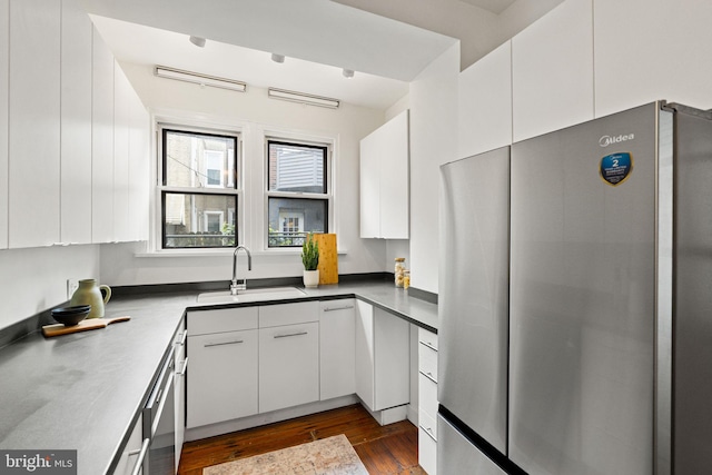 828 Mercer St, Philadelphia, PA 19125 - kitchen featuring appliances with stainless steel finishes, white cabinets, and dark wood finished floors