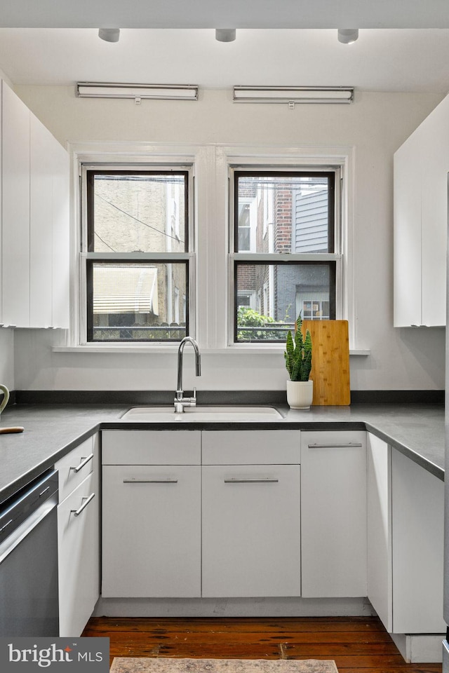 828 Mercer St, Philadelphia, PA 19125 - kitchen featuring stainless steel dishwasher, white cabinets, dark wood-type flooring, and modern cabinets