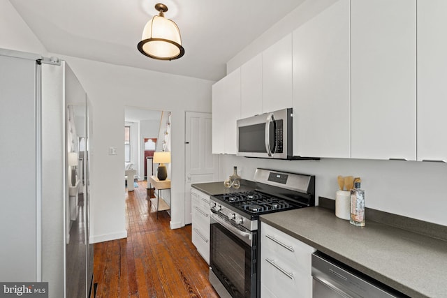828 Mercer St, Philadelphia, PA 19125 - kitchen with stainless steel appliances, dark countertops, dark wood-style floors, and white cabinets