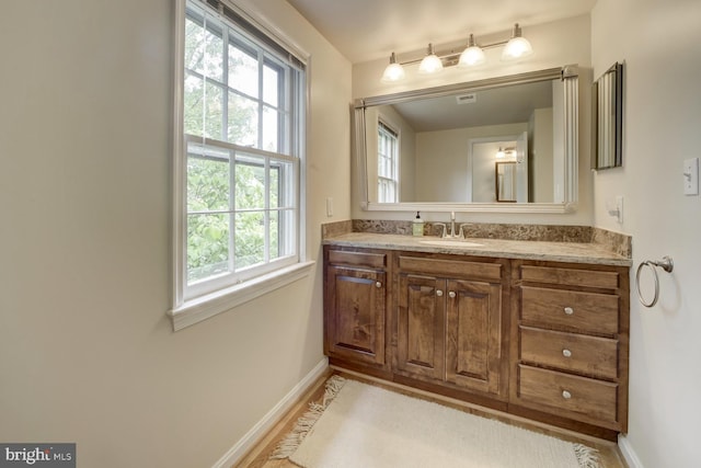 1109 Pipestem Pl, Potomac, MD 20854 - bathroom featuring healthy amount of natural light, vanity, and wood finished floors