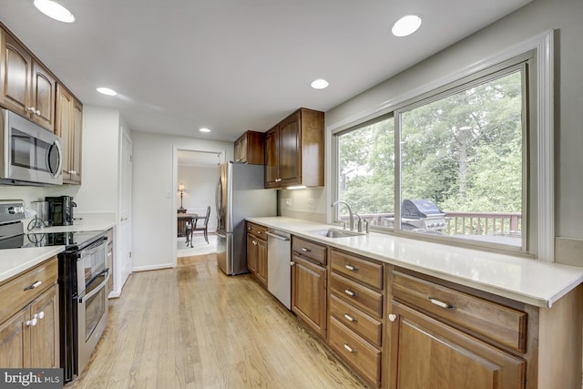 1109 Pipestem Pl, Potomac, MD 20854 - kitchen featuring appliances with stainless steel finishes, plenty of natural light, light wood finished floors, light countertops, and recessed lighting
