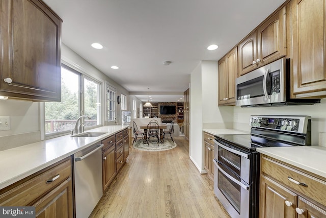1109 Pipestem Pl, Potomac, MD 20854 - kitchen with appliances with stainless steel finishes, light wood finished floors, light countertops, recessed lighting, and brown cabinetry