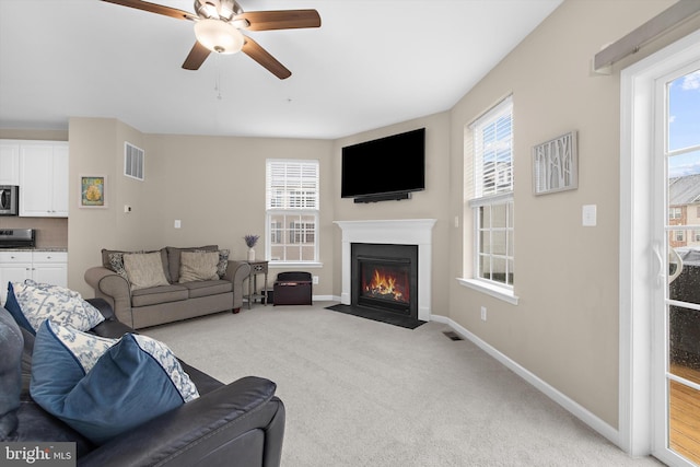 7802 Richard Halley Way, Elkridge, MD 21075 - living room with carpet floors, a ceiling fan, and a fireplace with flush hearth