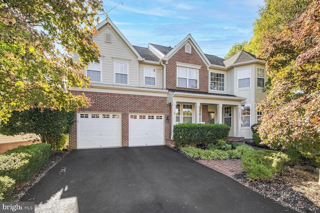 14401 Chalfont Dr, Haymarket, VA 20169 - view of front of house with brick siding, asphalt driveway, and a garage