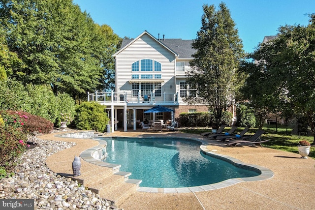 14401 Chalfont Dr, Haymarket, VA 20169 - back of property with a patio area, a balcony, and an outdoor pool