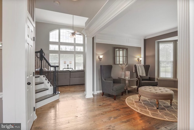 14401 Chalfont Dr, Haymarket, VA 20169 - sitting room with crown molding, stairway, wood finished floors, decorative columns, and a chandelier