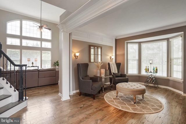 14401 Chalfont Dr, Haymarket, VA 20169 - living area featuring crown molding, stairway, wood-type flooring, and ornate columns