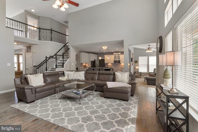 14401 Chalfont Dr, Haymarket, VA 20169 - living area featuring ceiling fan, hardwood / wood-style floors, a towering ceiling, and stairs