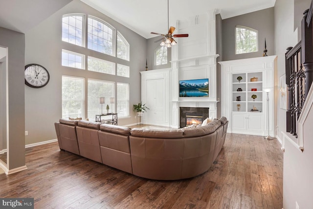 14401 Chalfont Dr, Haymarket, VA 20169 - living area with a high ceiling, a fireplace, a ceiling fan, dark wood finished floors, and stairs