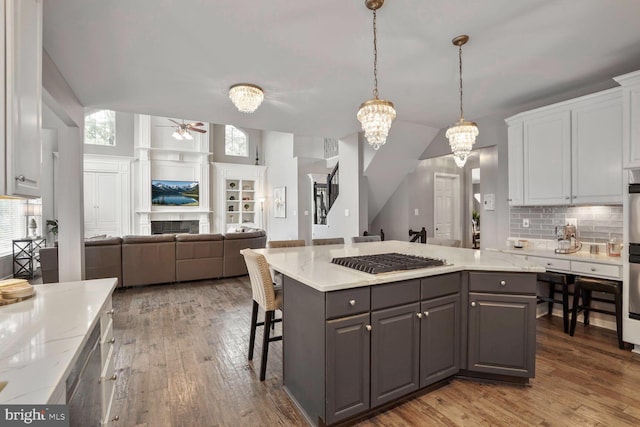 14401 Chalfont Dr, Haymarket, VA 20169 - kitchen with gray cabinetry, stainless steel gas cooktop, ceiling fan, and hardwood / wood-style flooring
