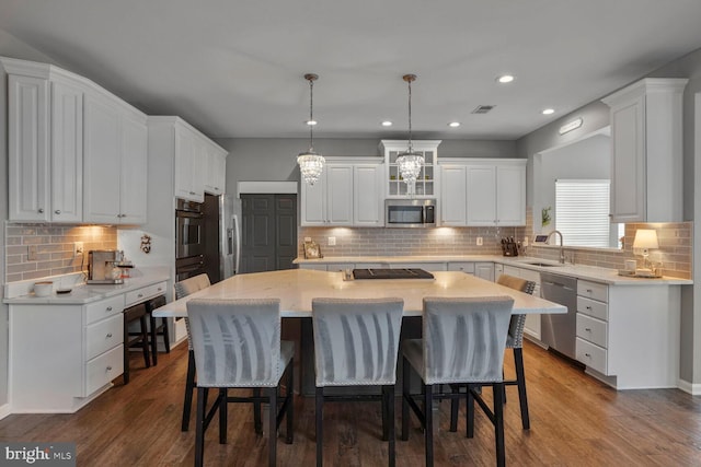 14401 Chalfont Dr, Haymarket, VA 20169 - kitchen featuring stainless steel appliances, tasteful backsplash, a kitchen island, white cabinetry, and recessed lighting