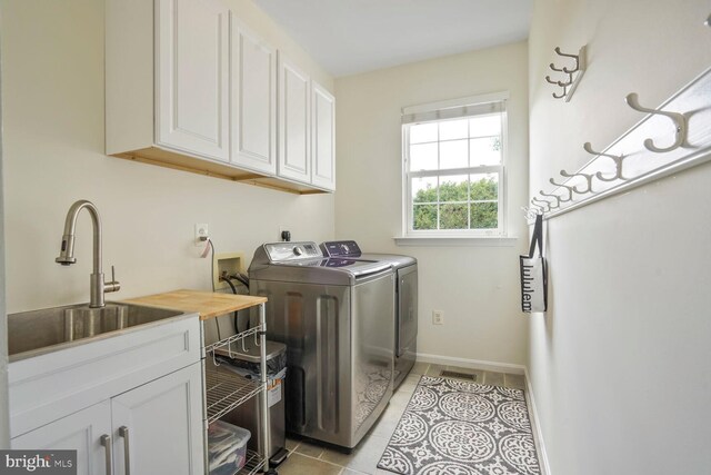 14401 Chalfont Dr, Haymarket, VA 20169 - laundry room with cabinet space, washer and clothes dryer, and light tile patterned flooring