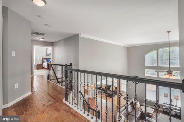 14401 Chalfont Dr, Haymarket, VA 20169 - corridor with hardwood / wood-style floors, ornamental molding, and an upstairs landing