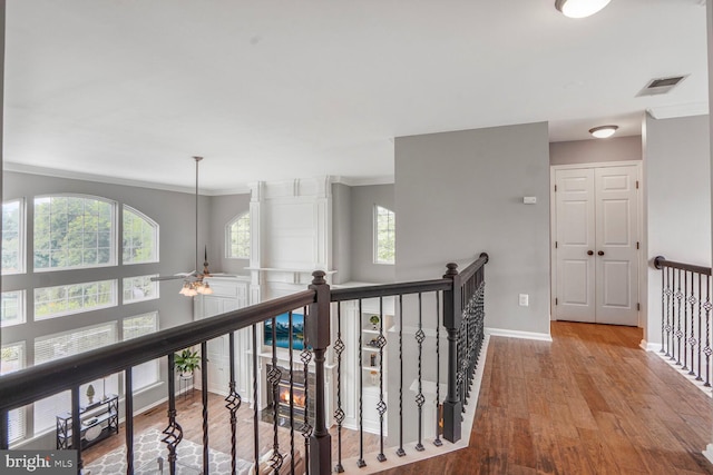 14401 Chalfont Dr, Haymarket, VA 20169 - hallway featuring crown molding, wood finished floors, and an upstairs landing