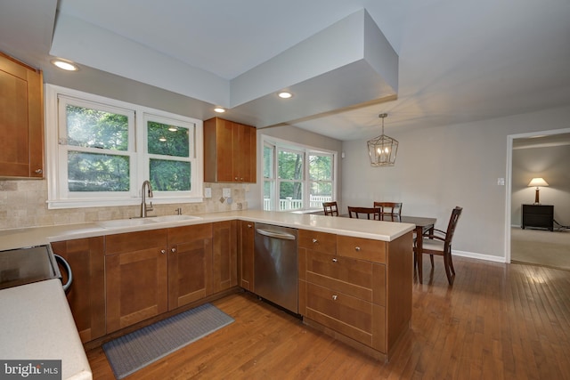 561 Nottingham Dr, Yardley, PA 19067 - kitchen featuring stainless steel dishwasher, brown cabinetry, a peninsula, hardwood / wood-style flooring, and recessed lighting