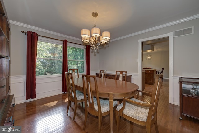 561 Nottingham Dr, Yardley, PA 19067 - dining area with a chandelier, hardwood / wood-style flooring, wainscoting, crown molding, and a decorative wall
