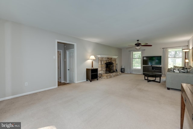 561 Nottingham Dr, Yardley, PA 19067 - living room with light colored carpet, ceiling fan, and a stone fireplace