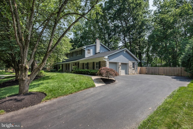 561 Nottingham Dr, Yardley, PA 19067 - view of front of home featuring a chimney, an attached garage, asphalt driveway, and stone siding