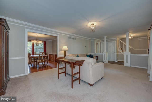 561 Nottingham Dr, Yardley, PA 19067 - living room featuring light colored carpet, ornamental molding, a chandelier, decorative columns, and stairway