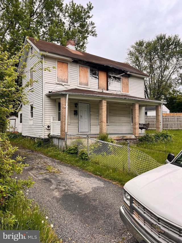 518 Ingleside Ave, Baltimore, MD 21228 - view of property with a porch, a fenced front yard, and a chimney