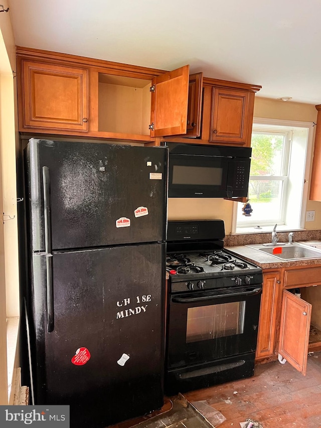 518 Ingleside Ave, Baltimore, MD 21228 - kitchen featuring black appliances, wood finished floors, and brown cabinetry