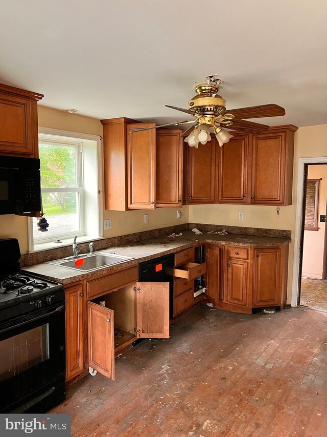 518 Ingleside Ave, Baltimore, MD 21228 - kitchen with black appliances, brown cabinetry, a ceiling fan, hardwood / wood-style flooring, and dark countertops
