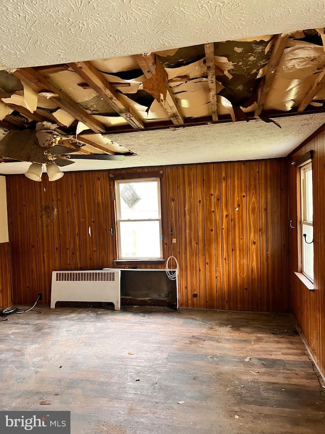 518 Ingleside Ave, Baltimore, MD 21228 - misc room with radiator, plenty of natural light, wooden walls, a textured ceiling, and hardwood / wood-style flooring