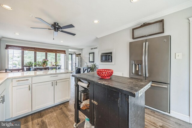 487 College Blvd, Wenonah, NJ 08090 - kitchen with stainless steel appliances, crown molding, ceiling fan, wood finished floors, and white cabinetry