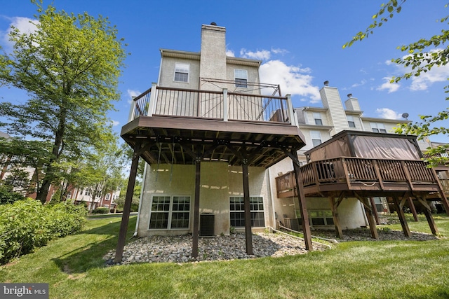 205 Dylan Dr Unit 54, Lansdale, PA 19446 - rear view of house featuring a deck, a lawn, stucco siding, and a chimney