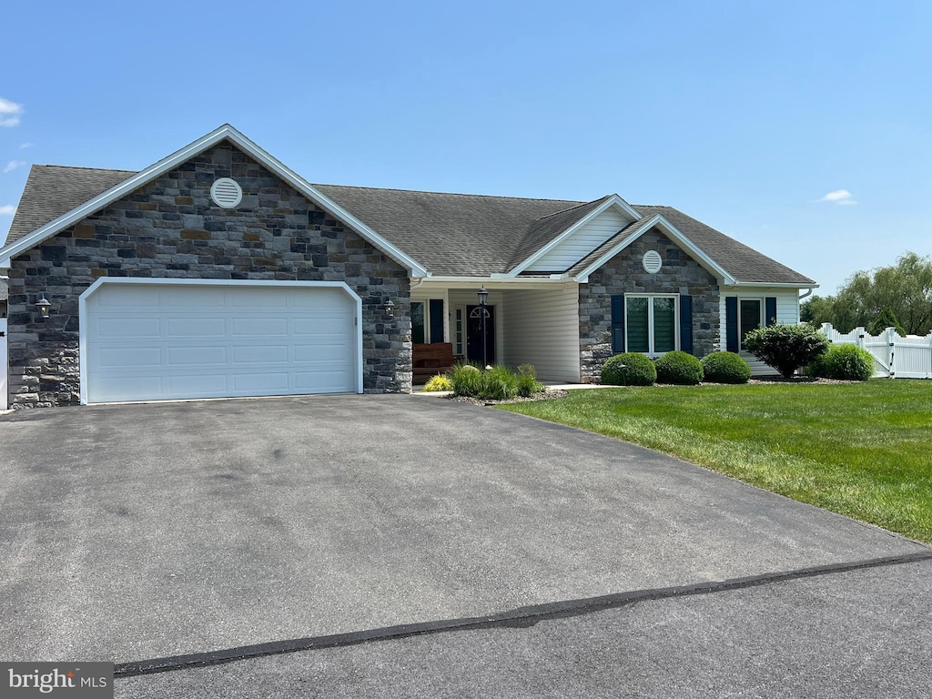 123 Quentin Cir Unit 9, Shippensburg, PA 17257 - single story home with stone siding, an attached garage, driveway, a front yard, and roof with shingles