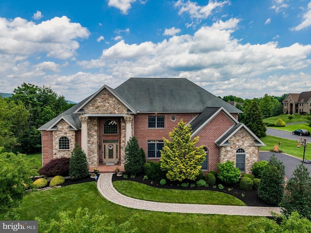 1720 Adeline Dr, Mechanicsburg, PA 17050 - view of front of property featuring stone siding, a front yard, brick siding, and a shingled roof