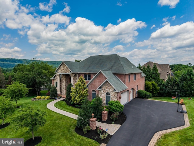 1720 Adeline Dr, Mechanicsburg, PA 17050 - view of front of home featuring a garage, stone siding, driveway, and a front lawn