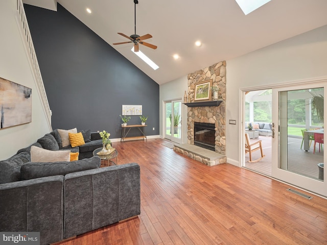 21 Shara Ln, Pennington, NJ 08534 - living room with a skylight, high vaulted ceiling, a ceiling fan, wood finished floors, and a fireplace