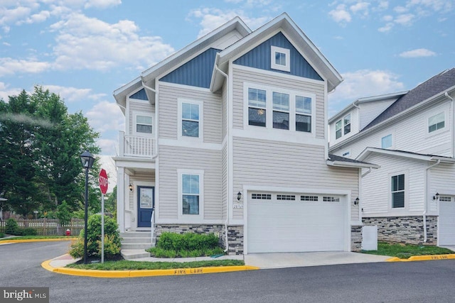 20769 Partlows Store Sq, Ashburn, VA 20147 - view of front of property with board and batten siding, stone siding, a garage, and driveway