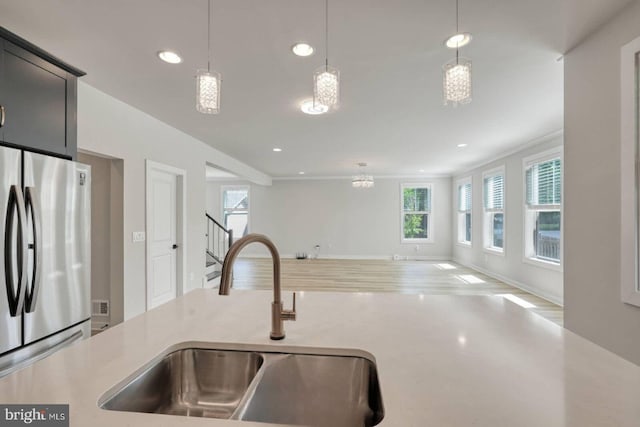 20769 Partlows Store Sq, Ashburn, VA 20147 - kitchen with freestanding refrigerator, light countertops, recessed lighting, open floor plan, and decorative light fixtures