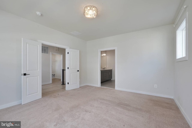 20769 Partlows Store Sq, Ashburn, VA 20147 - unfurnished bedroom featuring light colored carpet and ensuite bathroom