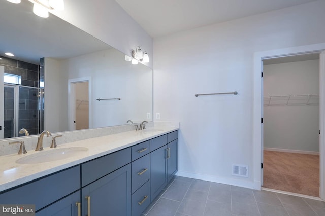 20769 Partlows Store Sq, Ashburn, VA 20147 - bathroom featuring double vanity, a spacious closet, a stall shower, and tile patterned flooring