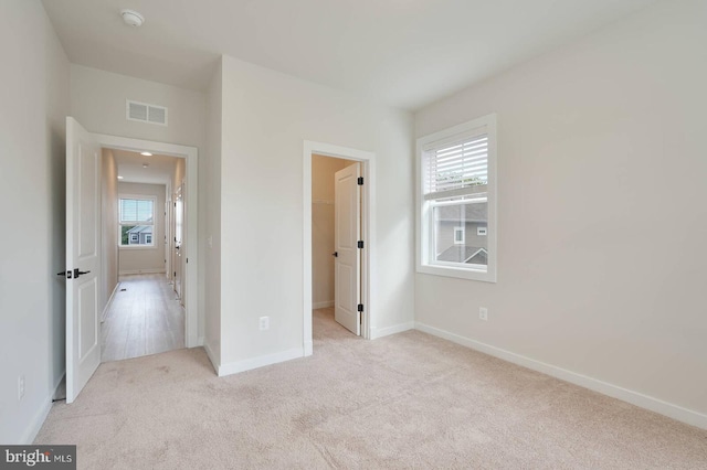 20769 Partlows Store Sq, Ashburn, VA 20147 - unfurnished bedroom featuring carpet floors and a walk in closet