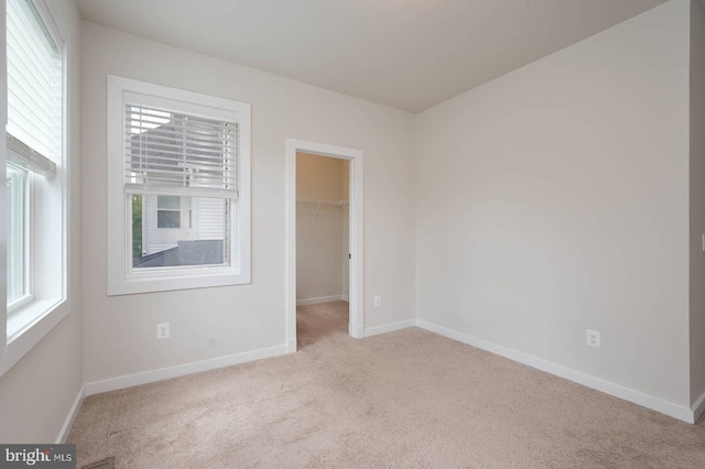 20769 Partlows Store Sq, Ashburn, VA 20147 - unfurnished bedroom featuring carpet flooring, a spacious closet, and a closet