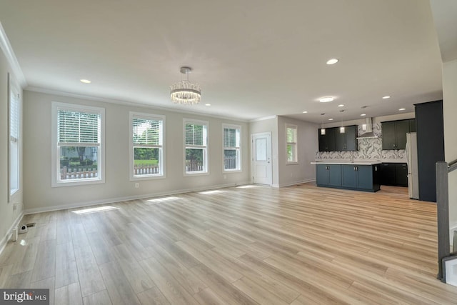 20769 Partlows Store Sq, Ashburn, VA 20147 - unfurnished living room with crown molding, a chandelier, recessed lighting, and light wood-style floors
