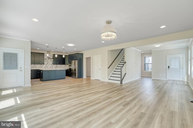 20769 Partlows Store Sq, Ashburn, VA 20147 - unfurnished living room featuring crown molding, stairway, a chandelier, recessed lighting, and light wood-type flooring
