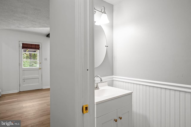 951 Robin Ln, Huntingdon Valley, PA 19006 - bathroom featuring vanity, wainscoting, wood finished floors, and a textured ceiling