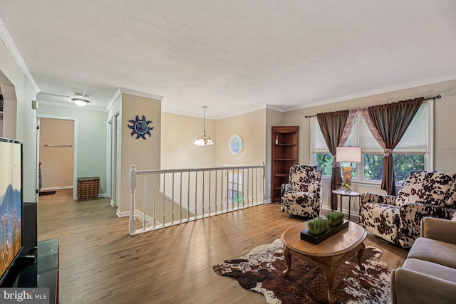 41 Sycamore Ln, Hanover, PA 17331 - living area featuring a textured ceiling, wood finished floors, crown molding, and a chandelier