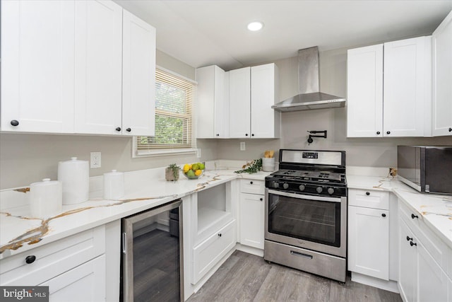 1427 Perrywood Dr, Aberdeen, MD 21001 - kitchen with gas stove, wine cooler, wall chimney range hood, white cabinetry, and recessed lighting