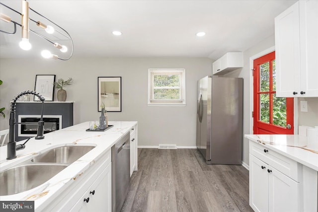 1427 Perrywood Dr, Aberdeen, MD 21001 - kitchen with appliances with stainless steel finishes, wood finished floors, white cabinetry, recessed lighting, and light stone countertops