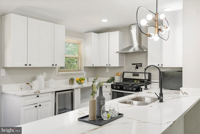 1427 Perrywood Dr, Aberdeen, MD 21001 - kitchen featuring wine cooler, wall chimney exhaust hood, stainless steel gas range, white cabinets, and recessed lighting