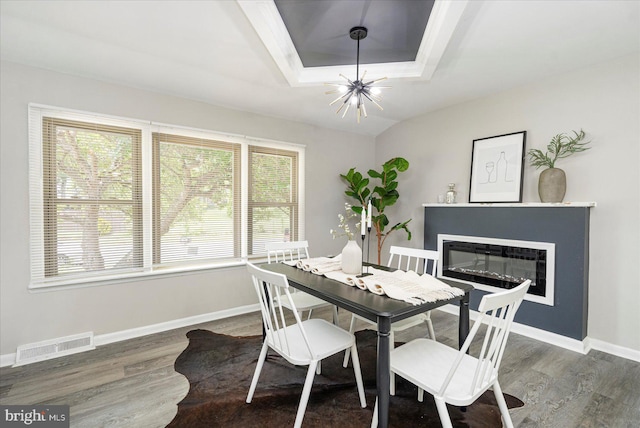 1427 Perrywood Dr, Aberdeen, MD 21001 - dining room featuring a chandelier, wood finished floors, a tray ceiling, and a glass covered fireplace