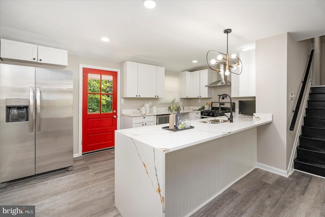 1427 Perrywood Dr, Aberdeen, MD 21001 - kitchen featuring appliances with stainless steel finishes, a peninsula, light wood-style flooring, white cabinets, and recessed lighting
